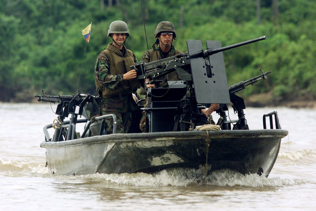 Colombian soldiers patrol aboard a highspeed, armored boat over the Caquetá river during an army training near Tres Esquinas army base. (REUTERS/Daniel Munoz) 