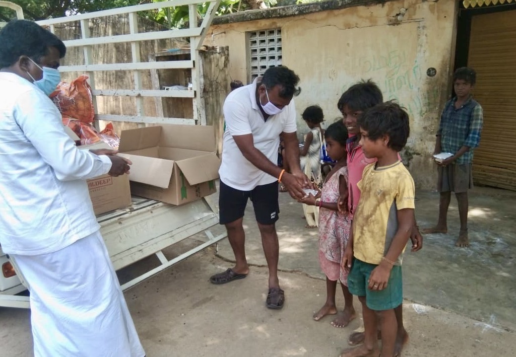 men giving children meals