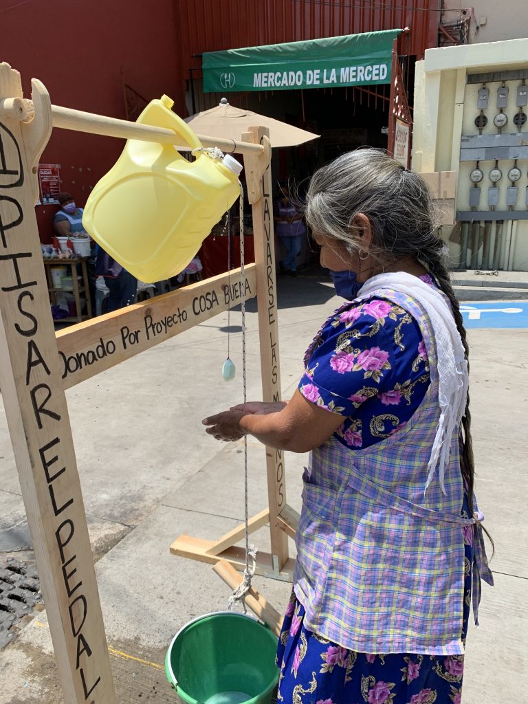 Woman washing her hands at handwashing station